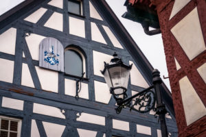 Typical half-timbered house facade in Seligenstadt, painted wooden window shutter Typical half-timbered house facade in Seligenstadt, painted wooden window shutter